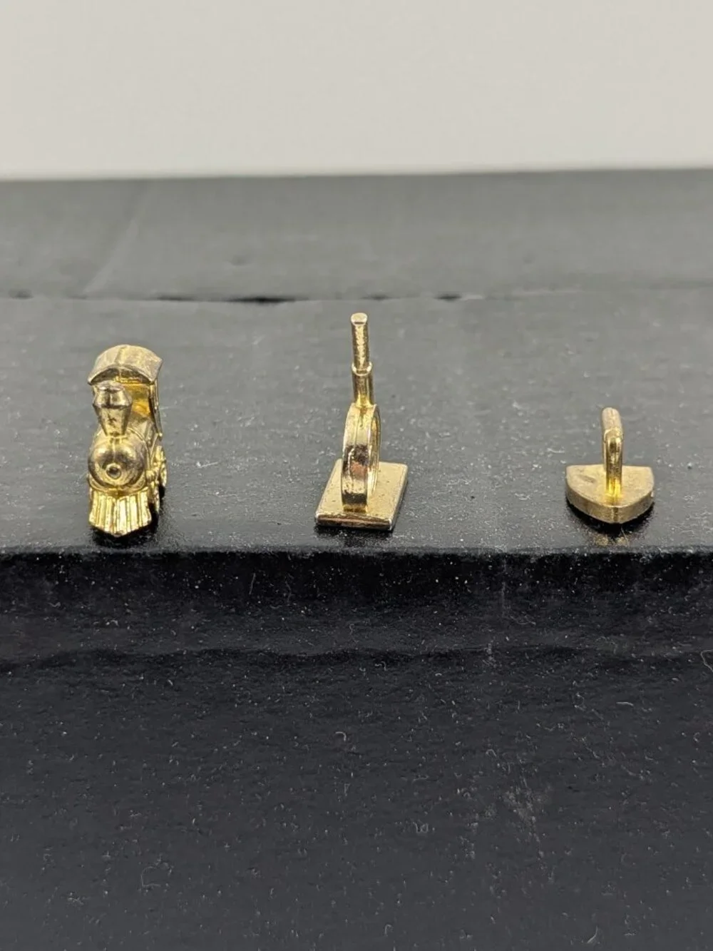 Three gold color monopoly replacement pieces train, canon, iron